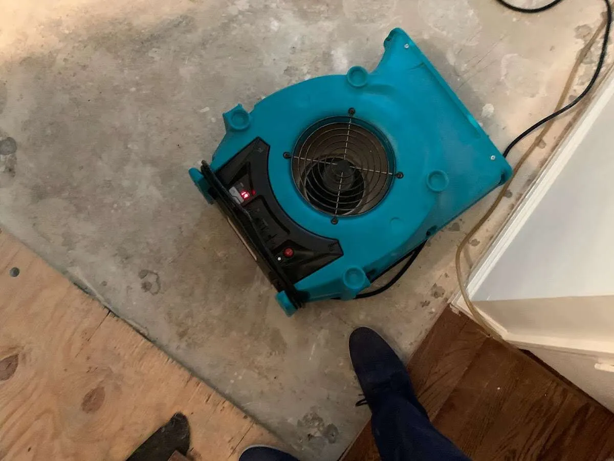 Air mover drying subfloor during Commercial Water Damage Restoration in Good Hope